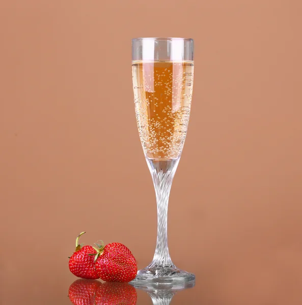 A glass of champagne on a beige background — Stock Photo, Image