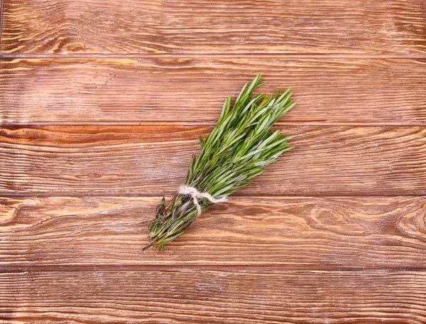 Rosemary bound on a wooden board — Stock Photo, Image