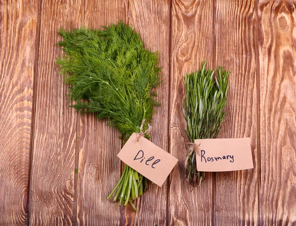 Different fresh herbs on wooden background — Stock Photo, Image