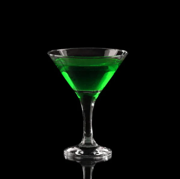 Green alcoholic cocktail in a glass on black — Stock Photo, Image