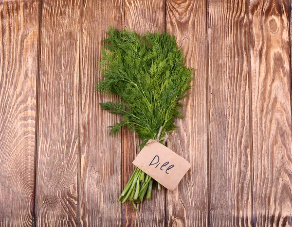 Fresh green dill on old wooden background — Stock Photo, Image