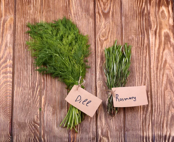 Different fresh herbs on wooden background — Stock Photo, Image