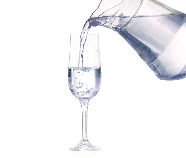 Pouring water from glass pitcher on white background — Stock Photo, Image