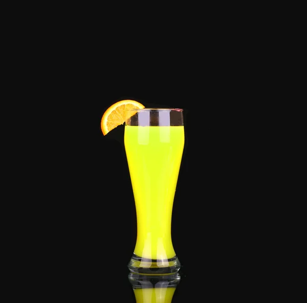 Yellow alcoholic cocktail with a slice of orange on a black background — Stock Photo, Image