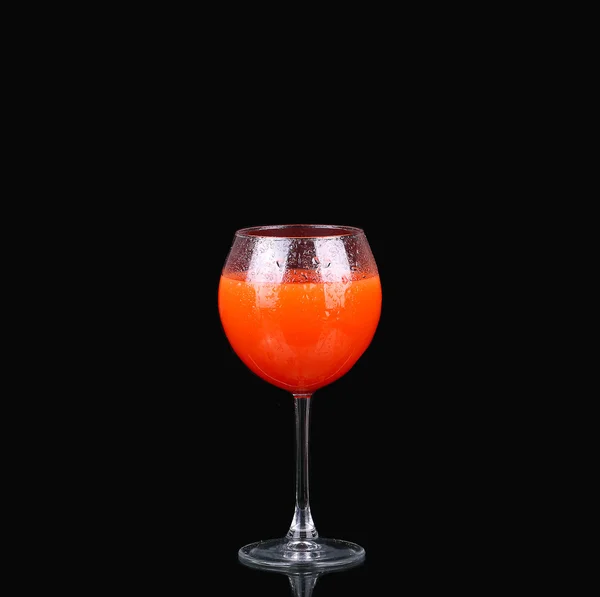 A glass of grapefruit juice on a black background — Stock Photo, Image