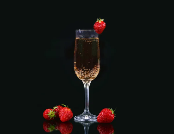 Bicchiere di champagne freddo con fragole su sfondo nero — Foto Stock