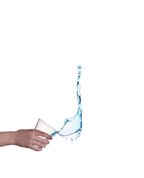 Blue water splashing in glass held by hand, white background — Stock Photo, Image