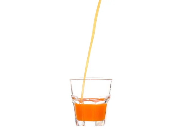 Juice pouring into glass isolated on white — Stock Photo, Image