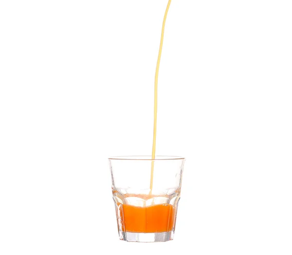 Juice pouring into glass isolated on white — Stock Photo, Image