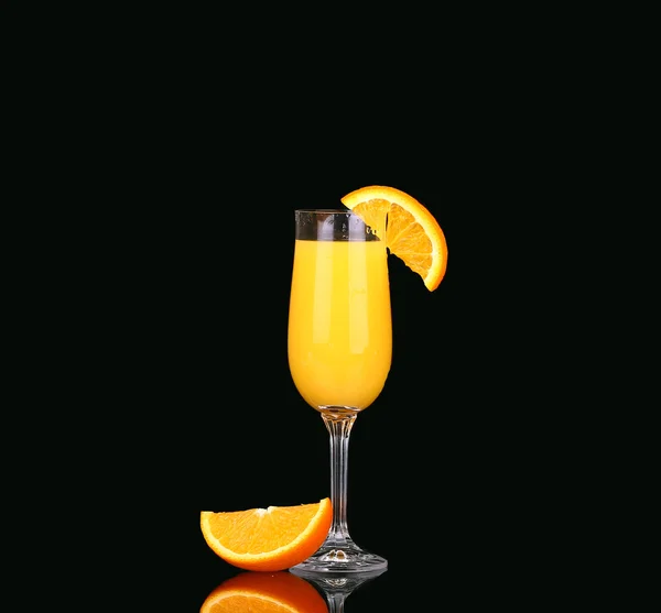 Fresh organic orange juice and vodka in a tall glass  on a black background — Stock Photo, Image