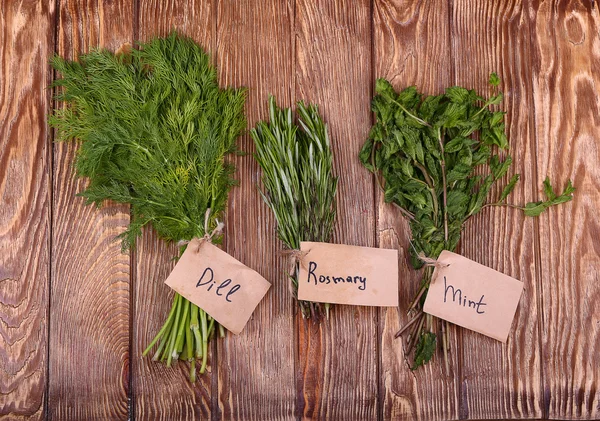 Fresh herbs hanging over wooden background — Stock Photo, Image