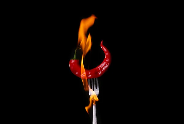 Fork impale to red hot chili on black background. — Stock Photo, Image