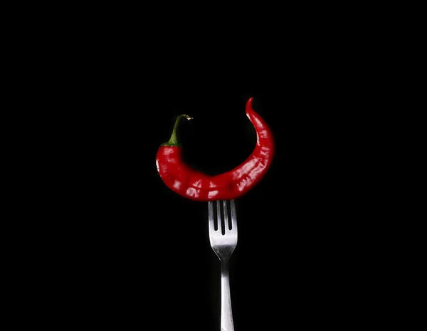 Paper chili on fork on black background — Stock Photo, Image