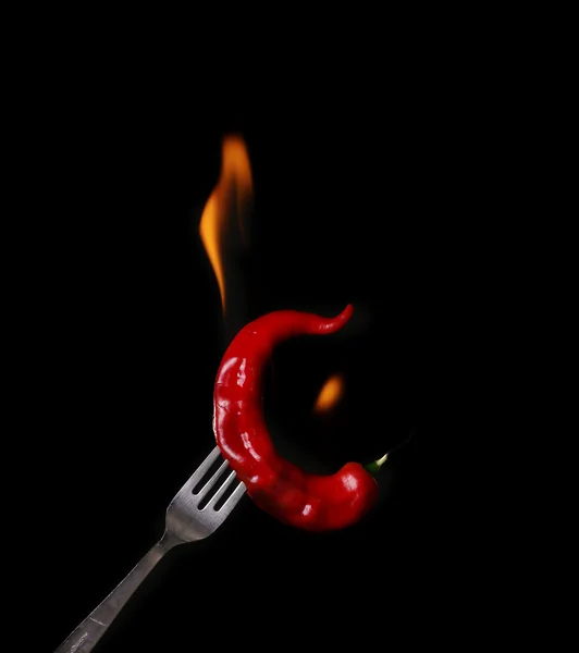 Fork impale to red hot chili on black background. — Stock Photo, Image