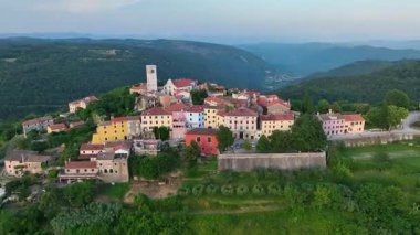 Yaz boyunca Hırvatistan 'ın Istria kentindeki Oprtalj tepesindeki ortaçağ kasabasının hava aracı görüntüleri. Tarihi taş evler, dar sokaklar, çevre tepeler ve otantik Avrupa manzarası.