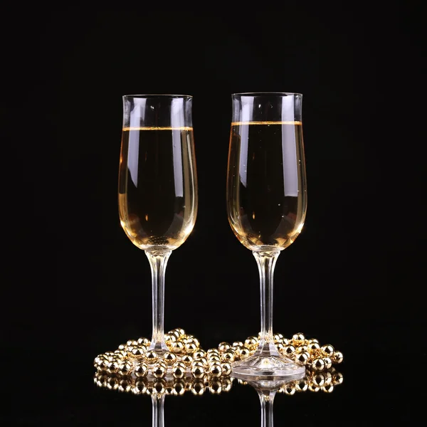 Glass of champagne with splash, on black background — Stock Photo, Image