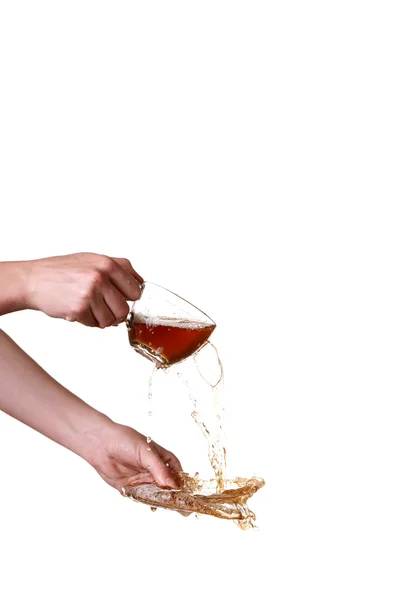 Brown splashes out drink from glass on a white background. — Stock Photo, Image