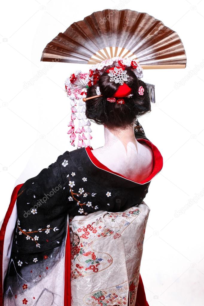 young pretty geisha in kimono with sakura and decoration