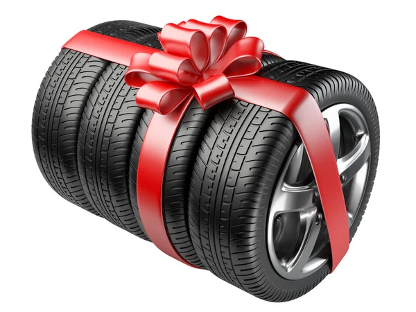 Gift set tyres with a wrapped red ribbon and bow. — Stock Photo, Image