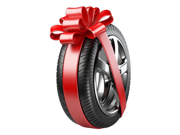 Tyre with a wrapped red ribbon and bow. — Stock Photo, Image