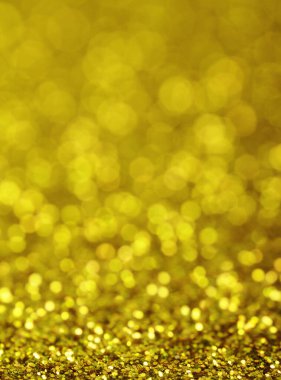 Noel 'in altın sarısı arka planı. Altın Tatil Yeni Yıl soyut parıltı sönmüş ışıklar. Bulanık Bokeh.