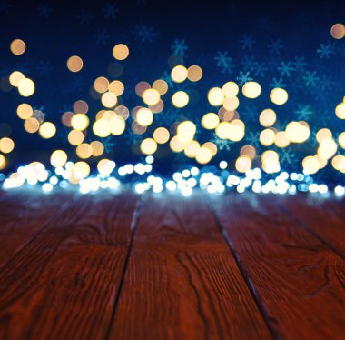 Altın bokeh ve noel ışıklandırmalı boş ahşap bir masa.