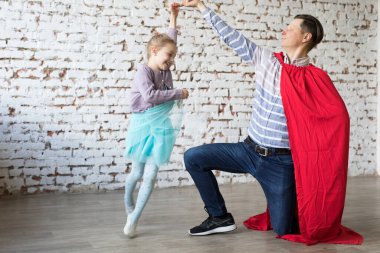 happy father in superhero costume and his daughter clipart