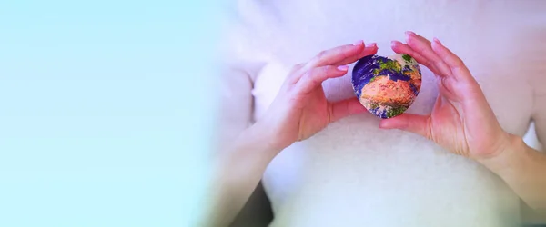 Earth in the shape of a heart in the hands — Stock Photo, Image