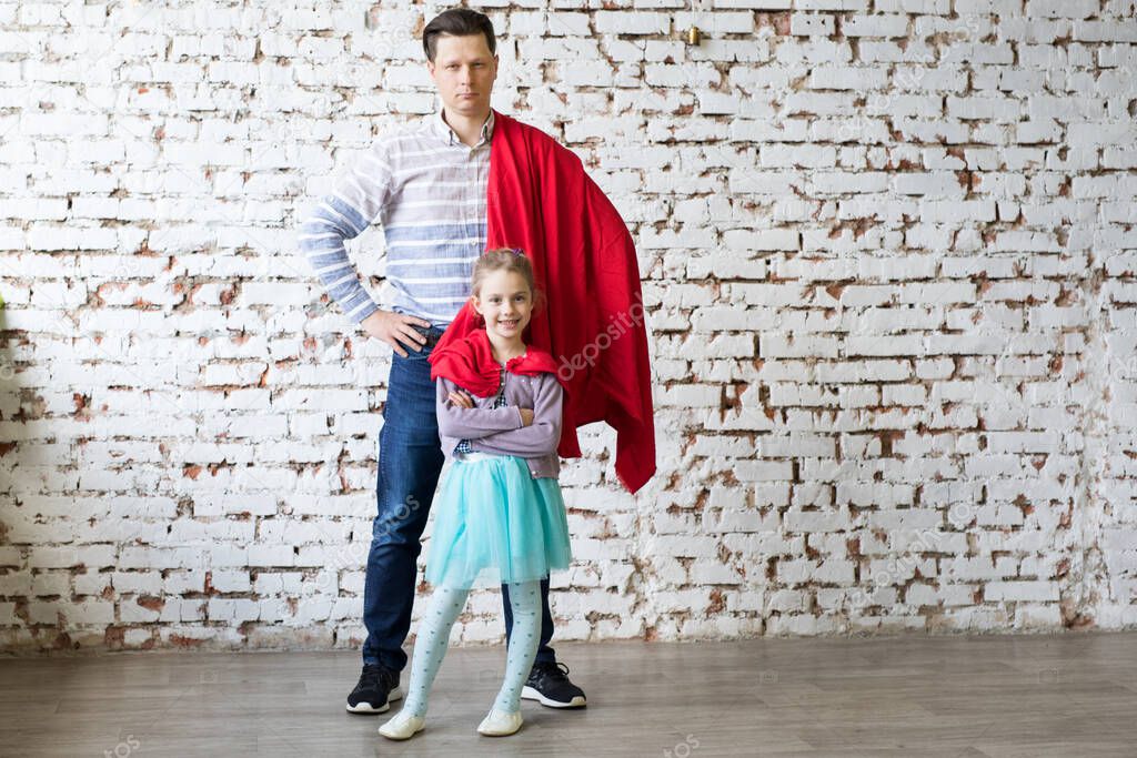 happy father in superhero costume and his daughter