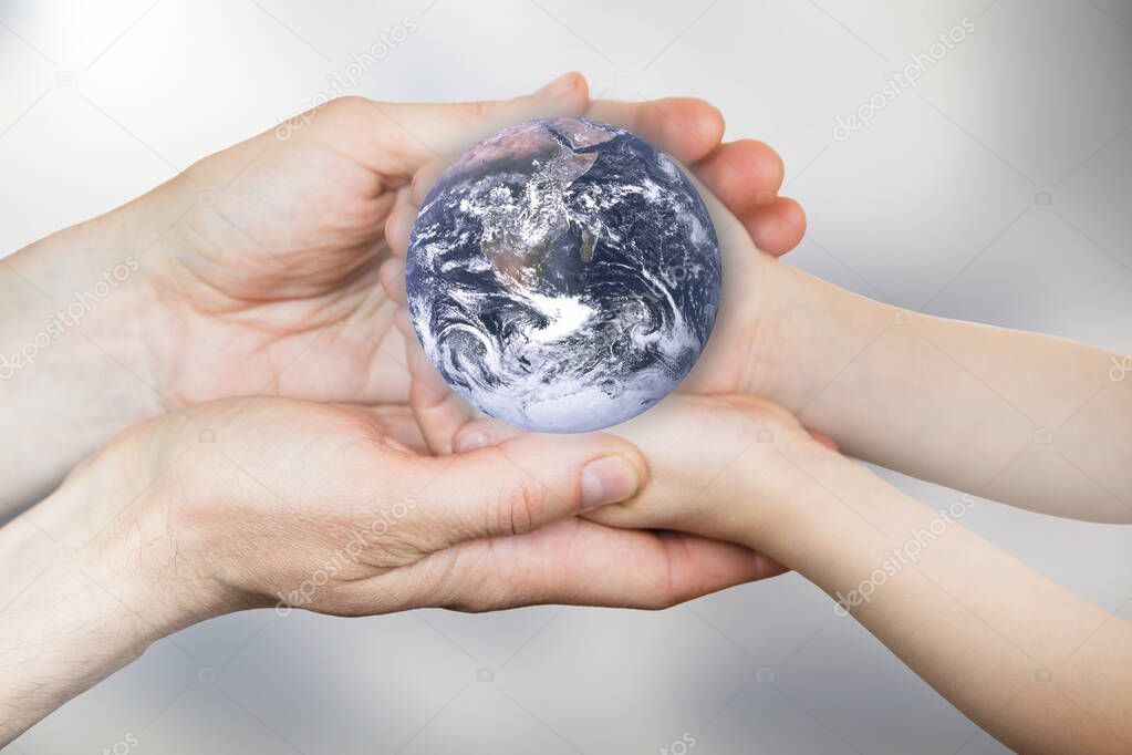 Globe in the hands. Elements of this image furnished by NASA