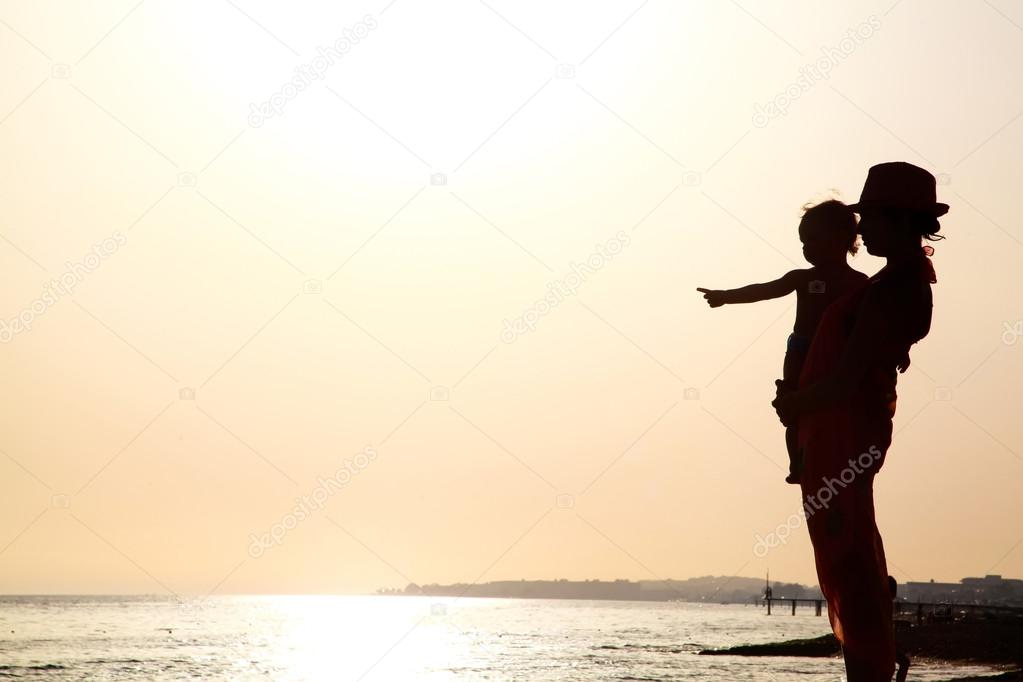 Woman with baby at the sunset