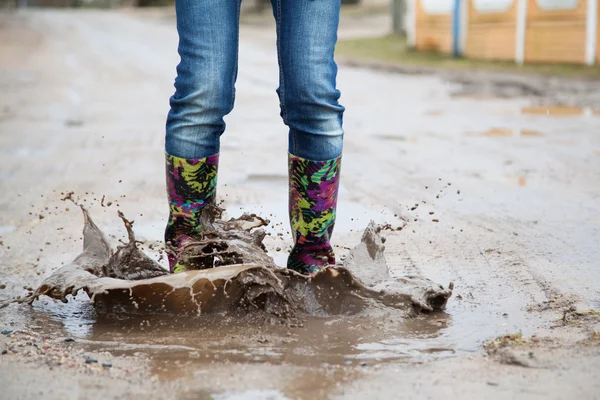 Woman with rain boots jumps — Stock Photo, Image