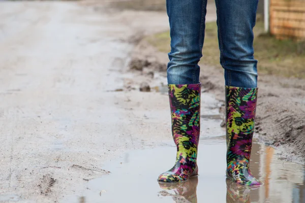 Woman with rain boots jumps — Stock Photo, Image