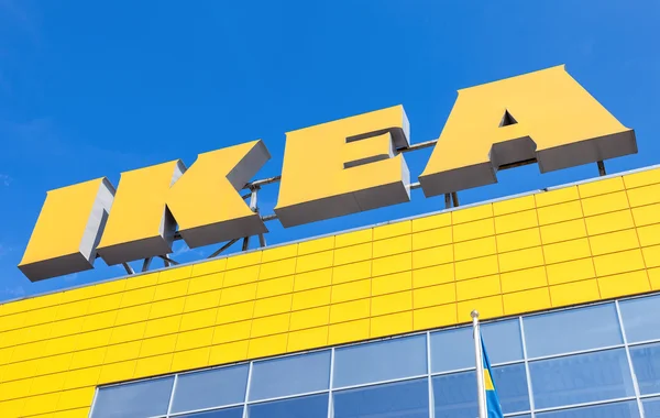 IKEA logo against blue sky. IKEA is the world's largest furnitur — Stock Photo, Image