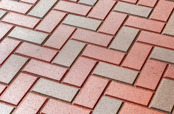 Pedras de pavimentação vermelho e cinza como fundo close-up — Fotografia de Stock