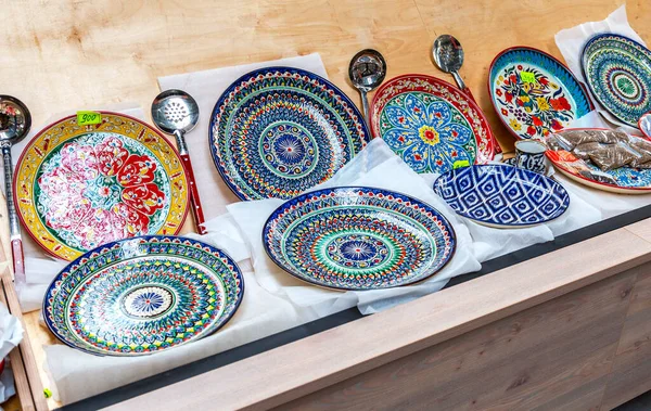 Ethnic Uzbek ceramic round plates with traditional Uzbek ornaments. Decorative ceramic plates with patterns