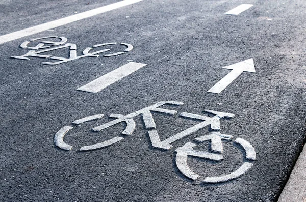 Bicycle symbol on a bike lane with directional arrow of movement. Bicycle lane for bike rider