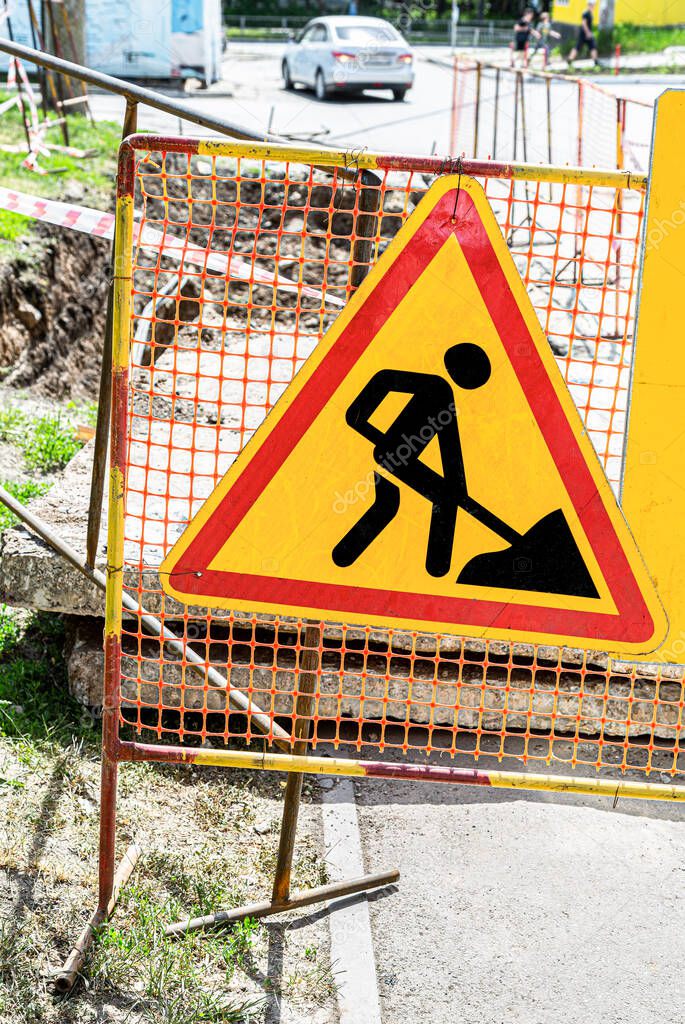 Road works traffic sign at the city street. Road under construction