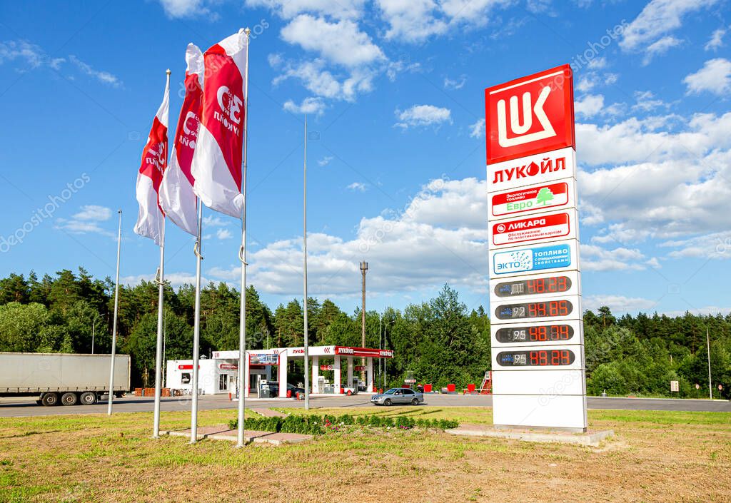 Mordovia, Russia - July 6, 2021: Lukoil gas station with fueling cars. Lukoil is one of the largest russian oil companies