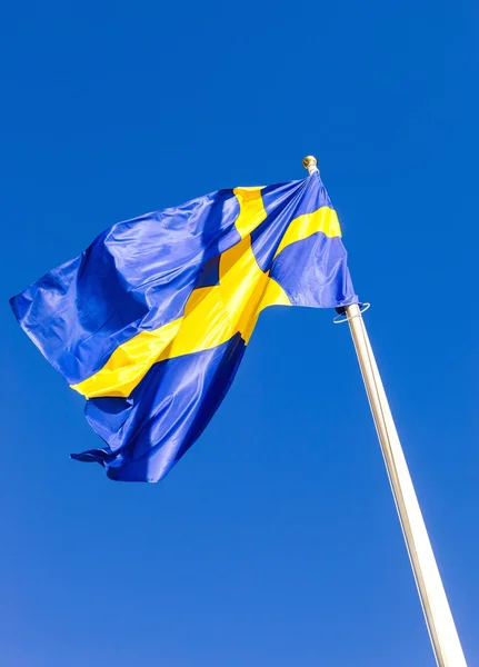 Flag of Sweden waving against blue sky — Stock Photo, Image