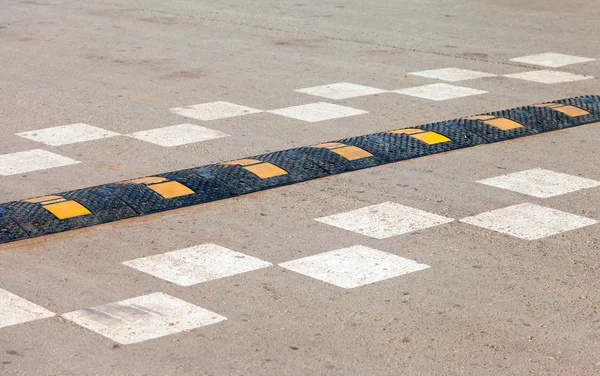 Traffic safety speed bump on an asphalt road — Stock Photo, Image