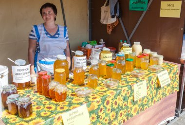 SAMARA, RUSSIA - SEPTEMBER 7, 2014: Women seller of honey on the clipart