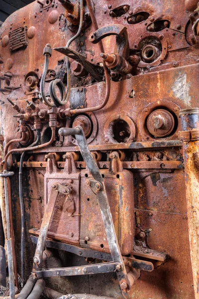 Old steam train engine with rust and damage
