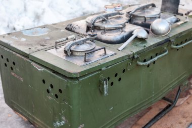 Mobile metal kitchen stove to feed soldiers clipart