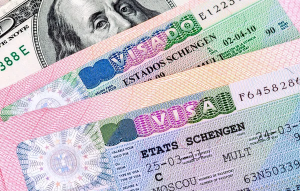 Fragment of Schengen visa in passport and american dollar bankno — Stock Photo, Image