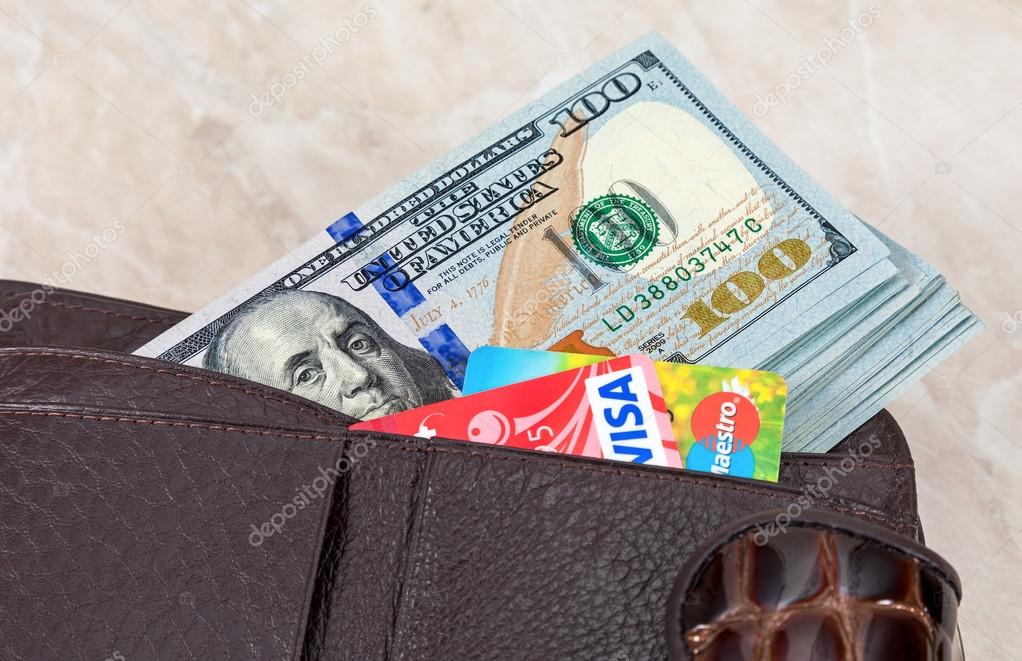 SAMARA, RUSSIA - APRIL 17, 2015: Wallet with american dollars and credit cards