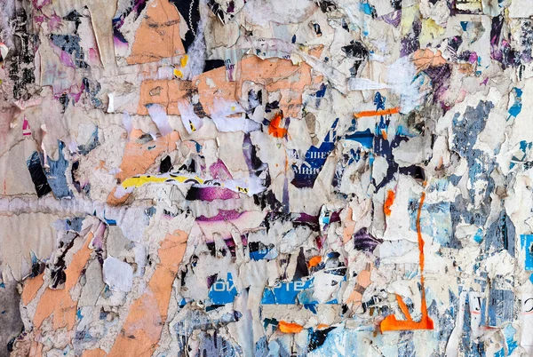 Wall with scraps of old paper as background — Stock Photo, Image