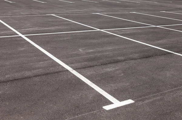 White traffic markings on a gray asphalt parking lot — Stock Photo, Image