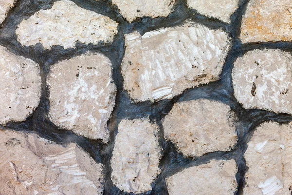 Fragment einer grauen Steinmauer als Hintergrund — Stockfoto
