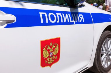 Polis arabasının üstündeki yazıt. Rusça metin: 